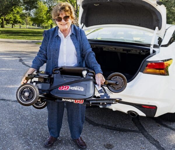 Betty-Holding-Scooter-Cropped-600×514